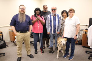 Brad Taylor (left) stands with a group of assistive technology clients.