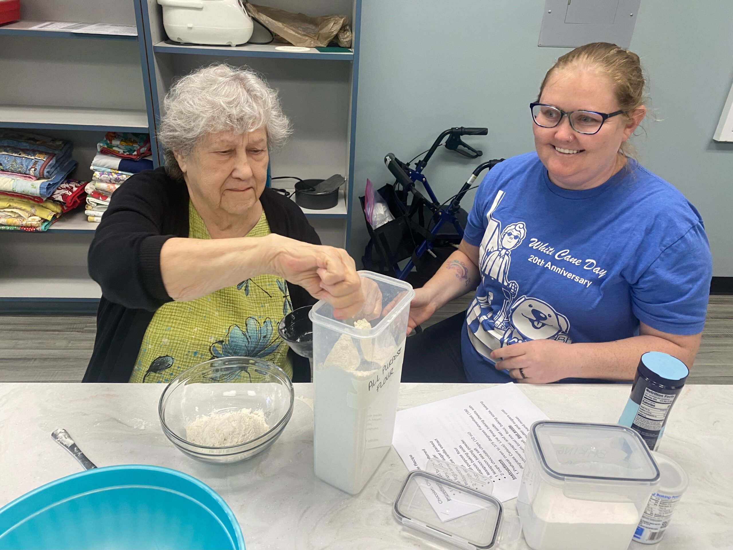 2025 Impact Report A Lighthouse client and team member work together to practice skills in the kitchen.